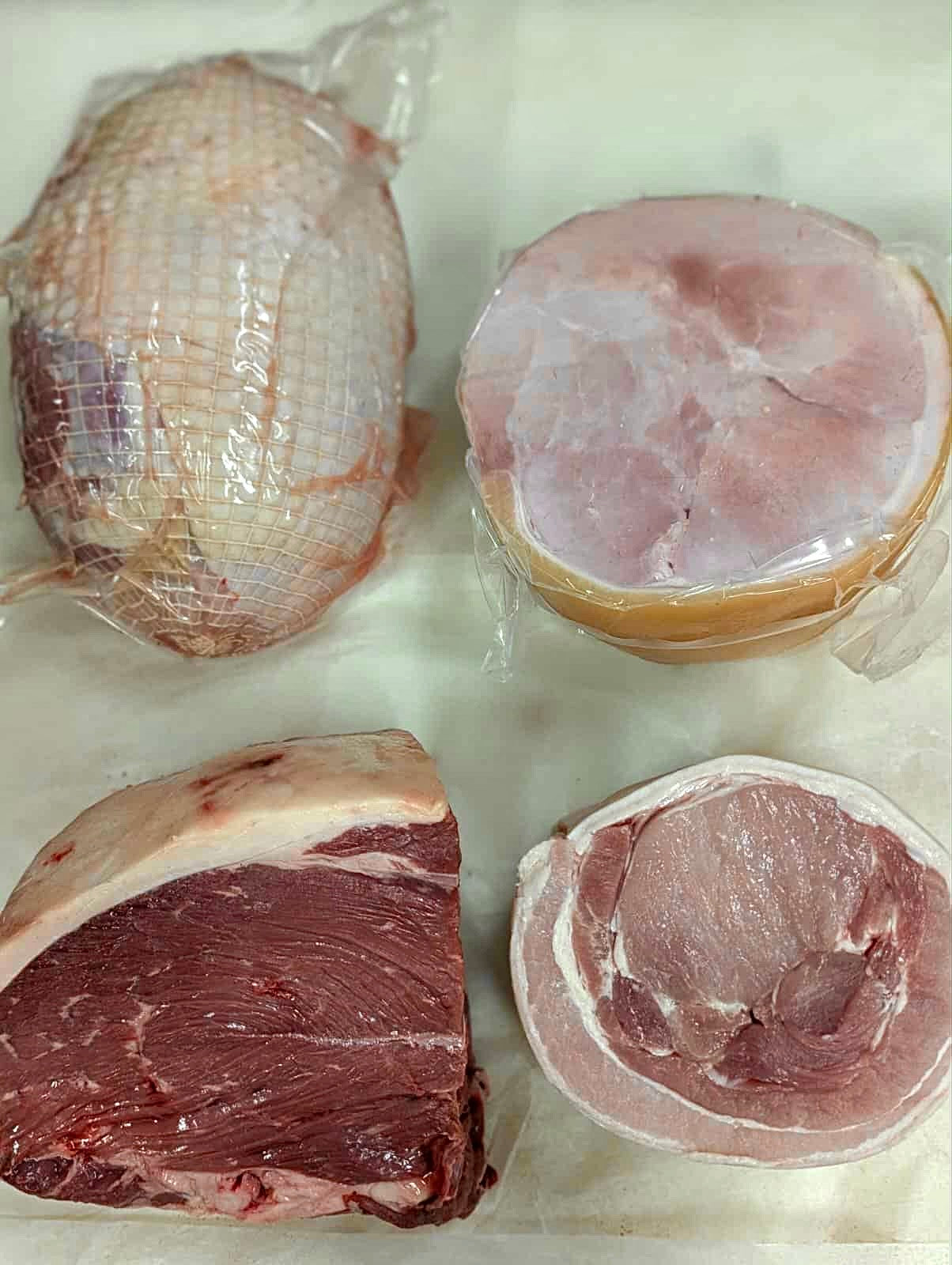 Assorted cuts of meat on a white surface